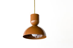 Close-up of the Taeuber Pendant in glossy fudge brown by Sazerac Stitches, showcasing its sculptural double-dome silhouette and glossy powder-coated finish with a brass downrod. This modern, handmade pendant light highlights the bold color and smooth craftsmanship of the design, perfect for kitchens, dining nooks, and modern interiors seeking a pop of color and midcentury-inspired style.