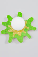 Vibrant splatter-shaped sconce in green and yellow with a frosted globe, perfect for modern interiors.
