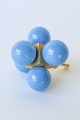Hydrangea blue and brass oversized ball cube drawer pull shown on a white background; designed with five lacquered blue spheres arranged in a cube formation on a polished brass base, perfect for high-end interior hardware styling.