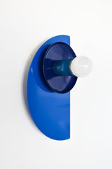This Kin Sconce layers three coastal-inspired shades of blue—Mediterranean, navy, and denim—into a striking piece of functional art. Its clean, architectural lines and matte-meets-gloss finish nod to Bauhaus and Memphis design, while the gradient of blue tones adds depth and drama. Perfect for contemporary homes, boutique hotels, or gallery-like spaces in need of sculptural lighting.