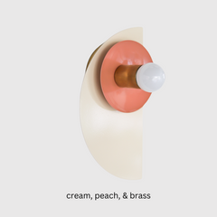 Geometric Kin Sconce in a serene cream and peach colorway with warm brass accents. This bold yet soft fixture blends Memphis-inspired form with timeless tones—ideal for mid-century modern, Scandinavian, or eclectic homes.