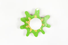 Vibrant splatter-shaped sconce in green and yellow with a frosted globe, perfect for modern interiors.