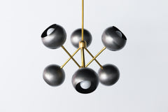 Steel and brass industrial inspired metal chandelier with globe shades.  Made in New Orleans. Unique lighting design