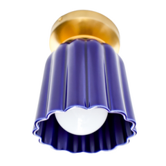 Marcella flushmount light fixture in glazed cobalt blue ceramic with a fluted Art Deco-inspired shape and warm brass canopy. A sculptural, handmade ceiling light perfect for hallways, powder rooms, or color-drenched interiors. Elegant blue ceramic flush mount with vintage charm.
