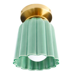 Jade green ceramic flush mount ceiling light with fluted Art Deco silhouette and brass canopy. Handmade sculptural lighting fixture designed for bathrooms, hallways, or entryways. Modern pastel green ceiling light adds a pop of color and vintage-inspired charm to interiors.