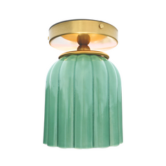 Jade green ceramic flush mount ceiling light with fluted Art Deco silhouette and brass canopy. Handmade sculptural lighting fixture designed for bathrooms, hallways, or entryways. Modern pastel green ceiling light adds a pop of color and vintage-inspired charm to interiors.