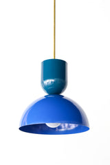 Close-up of the color-blocked Taeuber Pendant in grey blue and bright blue by Sazerac Stitches, featuring a glossy two-tone powder-coated finish and brass downrod. This sculptural pendant light showcases minimalist curves and handcrafted detailing, blending midcentury modern design with a soft, neutral palette. Perfect for kitchens, dining rooms, or entryways, this artisan-made fixture adds a timeless and elegant touch to both contemporary and classic interiors.