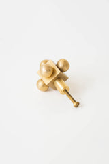 Small Brass Knob with Mid-Century Modern Influence – A minimalist brass cabinet knob with a geometric form, featuring four spheres and a central cube.