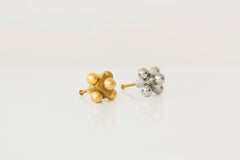 A set of two decorative knobs in brass and polished nickel, each featuring a cubic base with spherical accents.