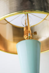 Overhead detail of the Mint & Ceramic Aqua Lamp showing polished brass hardware, filament bulb, and the reflective gold interior of the drum lampshade. Highlights premium craftsmanship and luxurious mid-century style finishes.