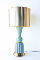Full view of a mint and aqua ceramic table lamp featuring a ribbed aqua ceramic base, glossy mint green sphere and cone details, and a reflective gold drum lampshade. Elegant brass accents highlight this artisan-made, mid-century inspired lighting fixture.