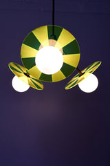 Playful pendant light casting a soft glow, available in Bright Blue, Medium Pink, or Neon Green.
