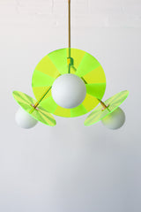 Mid-century modern pendant light fixture with colorful, etched acrylic discs.