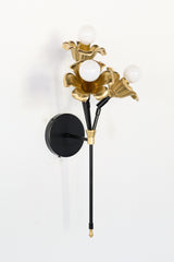 black and brass floral wall sconce.  Each socket includes a large brass flower.  Romantic and unique wall mounted wall sconce with three sockets.  Black and brass finish adds modernity
