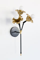black and brass floral wall sconce.  Each socket includes a large brass flower.  Romantic and unique wall mounted wall sconce with three sockets.  Black and brass finish adds modernity