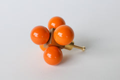 Orange Ball-Cube Knob – A bold orange and brass cabinet knob with five glossy spheres, photographed on a white background.