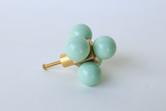 Mint Green Ball-Cube Knob on White Background – A brass cabinet knob with five glossy mint green balls on a brass cube base.  Bold, oversized drawer pull make a dramatic statement on furniture.