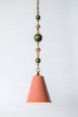 Full view of the Peach, Olive, & Rose Marble Beaded Pendant Light with peach cone shade, brass cap, and beaded chain featuring olive and rose marble accents.