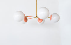 Peach & Brass modern chandelier. Mid Century modern style with oversize white globe shades.