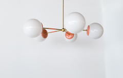 Peach & Brass modern chandelier. Mid Century modern style with oversize white globe shades.