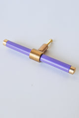 Pastel Purple and brass modern drawer pull.  Add color to cabinets with brass accents with the Piety drawer pulls by sazerac stitches.  Available in over 30 colors with the option to customize. Center mount installation drawer pull with color and brass accents.  Sophisticated colorful bathroom, dresser, vanity, or desk drawer pull.