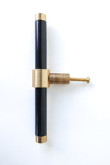 Glossy Black & Brass modern drawer pull.  Add color to cabinets with brass accents with the Piety drawer pulls by sazerac stitches.  Available in over 30 colors with the option to customize. Center mount installation drawer pull with color and brass accents.  Sophisticated colorful bathroom, dresser, vanity, or desk drawer pull.