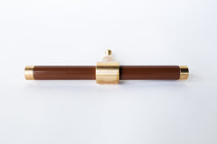 Glossy Medium Chocolate Fudge Brown & Brass modern drawer pull.  Add color to cabinets with brass accents with the Piety drawer pulls by sazerac stitches.  Available in over 30 colors with the option to customize. Center mount installation drawer pull with color and brass accents.  Sophisticated colorful bathroom, dresser, vanity, or desk drawer pull.