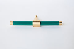 Rich, Emerald Green and brass modern drawer pull.  Add color to cabinets with brass accents with the Piety drawer pulls by sazerac stitches.  Available in over 30 colors with the option to customize. Center mount installation drawer pull with color and brass accents.  Sophisticated colorful bathroom, dresser, vanity, or desk drawer pull.