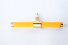 Yellow and brass modern drawer pull.  Add color to cabinets with brass accents with the Piety drawer pulls by sazerac stitches.  Available in over 30 colors with the option to customize. Center mount installation drawer pull with color and brass accents.  Sophisticated colorful bathroom, dresser, vanity, or desk drawer pull.