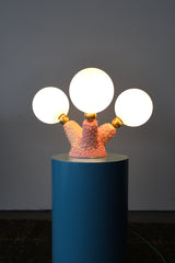 Close-up of handmade ceramic lighting base in pink and cream glaze with raised bubble texture, showcasing the artistic craftsmanship of the Pink Polyp Lamp