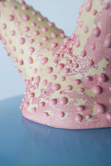Detail of textured pink ceramic lamp base with bumpy glaze, showing handcrafted polyp-inspired texture on unique art lamp