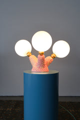 One-of-a-kind pink ceramic table lamp with quirky organic tentacle base and three illuminated globe bulbs, perfect for maximalist or offbeat home decor