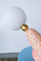 Macro shot of quirky pink handmade lamp base with layered ceramic texture, ideal for collectors of weird and whimsical lighting