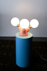 Close-up of handmade ceramic lighting base in pink and cream glaze with raised bubble texture, showcasing the artistic craftsmanship of the Pink Polyp Lamp