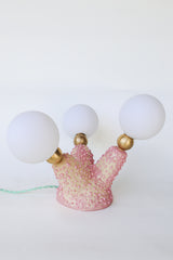 Top-down view of the Pink Polyp Lamp with three branching ceramic arms finished in hand-painted pastel and bubblegum pink glazes, each tipped with a G9 socket and frosted screw-on bulb, glowing softly to provide ambient light—an ideal accent for creative, maximalist interiors and one-of-a-kind decor lovers.
