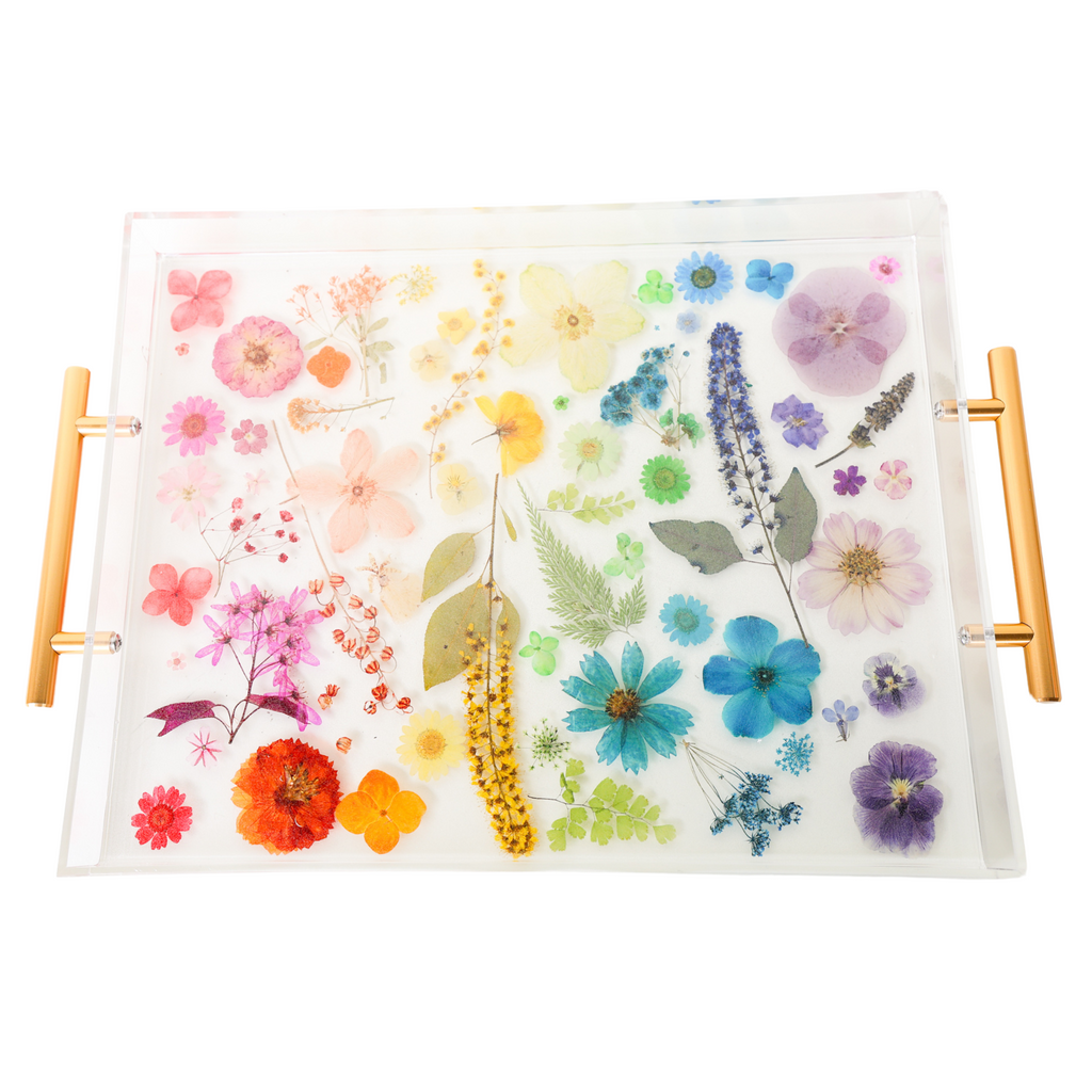 top down view with background removed  - Handmade acrylic tray featuring real dried and pressed flowers arranged in a rainbow gradient layout, with modern gold handles on either side. The flowers are suspended in clear resin, creating a vibrant, colorful design that is perfect for spring decor. Ideal for use as a vanity tray, coffee table tray, or bar accessory in bright, eclectic, or cottage-inspired interiors.