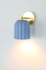Handcrafted soft blue ceramic sconce with matte unglazed finish and solid brass hardware; ideal for adding a subtle pop of color in coastal, preppy traditional, New England, granny chic, or modern cottage spaces — a charming choice for powder rooms, reading nooks, or entryways.