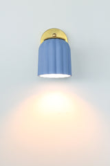 Handcrafted soft blue ceramic sconce with matte unglazed finish and solid brass hardware; ideal for adding a subtle pop of color in coastal, preppy traditional, New England, granny chic, or modern cottage spaces — a charming choice for powder rooms, reading nooks, or entryways.
