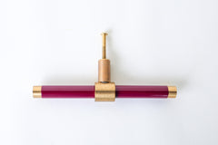 Black Cherry and brass modern drawer pull.  Add color to cabinets with brass accents with the Piety drawer pulls by sazerac stitches.  Available in over 30 colors with the option to customize. Center mount installation drawer pull with color and brass accents.  Sophisticated colorful bathroom, dresser, vanity, or desk drawer pull.