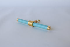 Poolside and brass modern drawer pull.  Add color to cabinets with brass accents with the Piety drawer pulls by sazerac stitches.  Available in over 30 colors with the option to customize. Center mount installation drawer pull with color and brass accents.  Sophisticated colorful bathroom, dresser, vanity, or desk drawer pull.