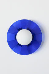 blue pop-art inspired wall sconce with etched stripes and a white glass globe.  Adds whimsy to any space. Picture of the light off in natural light.  Made in New Orleans by Sazerac Stitches.  Dark blue color.