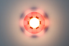 Pastel Pink pop-art inspired wall light fixture sconce.  Made of translucent pink acrylic that has been etched so that some parts are more opaque than others. The etching pattern is a stripe pattern.  Mimics pop art design and creates a fun shadow when the light is on.  Designed and made in New Orleans, LA.