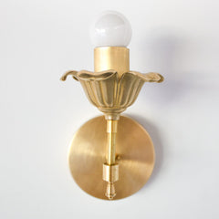 Brass floral wall sconce with cast brass detailing.  Modern take on traditional style brass light fixtures that retails old-world European charm with the finial and brass flower. Octavia wall sconce made by Sazerac Stitches in New Orleans