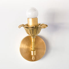 Brass floral wall sconce with cast brass detailing.  Modern take on traditional style brass light fixtures that retails old-world European charm with the finial and brass flower