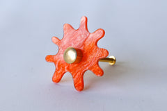 Orange Pearl Acrylic & Brass modern and artistic paint splat inspired drawer pull knob.  Colorful asymmetric acrylic drawer pull or knob with brass details. Adds a unique touch to dressers, cabinets, and more.  Comes in pearly, glossy, and translucent acrylic in a ton of colorful option.  Adds a playful touch to 90s aesthetic or a kid-friendly space.  Unique drawer pull made to order in New Orleans. Designed by Sazerac Stitches.  Easy to install!