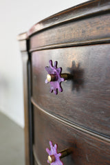 Wood nightstand with purple splat knobs attached