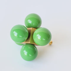 Bright grass green and brass statement knob that has balls on a centered cube.  Geometric, playful, and colorful oversized knob that will make a statement on any piece of furniture or cabinet.