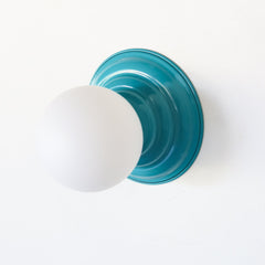 Teal and white glass small modern wall sconce that adds a pop of color