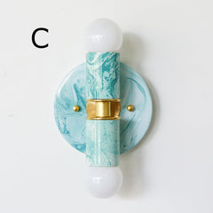 Hand-marbled modern two light wall sconce light fixture in pastel teal and.  Designed and made in New Orleans.  Colorful marbled lighting perfect for a maximalist bathroom, a pattern-loving interior designer, and more.  Each light fixture is unique.