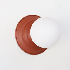 Terra Cotta Brown flush mount ceiling light or wall sconce with a frosted white globe. Stepping back into a bygone era with a touch of modern minimalism, the Abeille Sconce or Flushmount is an artistic blend of form and function. This wall sconce doubles as a flushmount ceiling light, making it a versatile lighting solution for any space. Designed akin to a beehive, its charismatic shape is complemented by curated color options that add a playful element to its retro appeal.